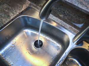 Sink with garbage disposal, water is running