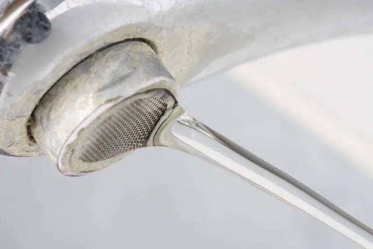 Running faucet with hard water buildup